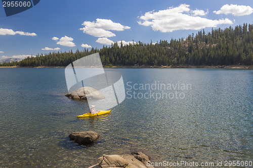 Image of Woman Kayaking on Beautiful Mountain Lake.