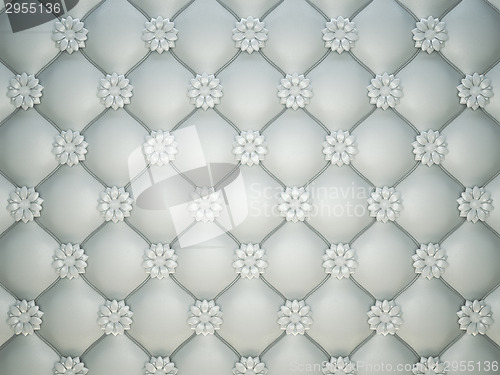 Image of white stitched leather pattern with flower buttons and bumps