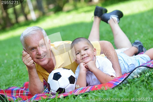 Image of happy grandfather and child in park