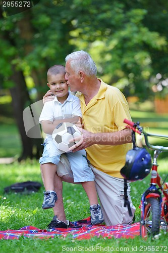 Image of happy grandfather and child in park