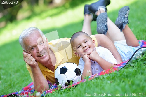 Image of happy grandfather and child in park