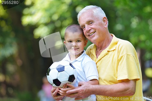 Image of happy grandfather and child in park