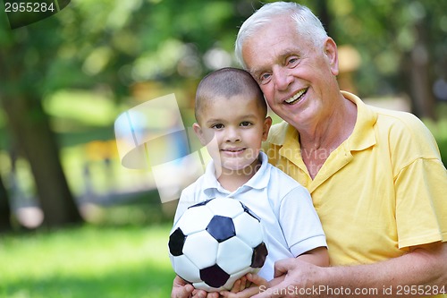 Image of happy grandfather and child in park