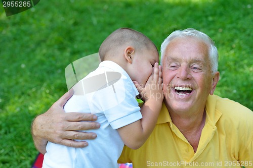 Image of happy grandfather and child in park