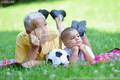 Image of happy grandfather and child in park