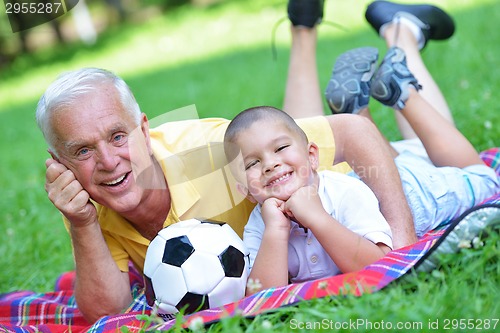 Image of happy grandfather and child in park