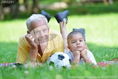 Image of happy grandfather and child in park