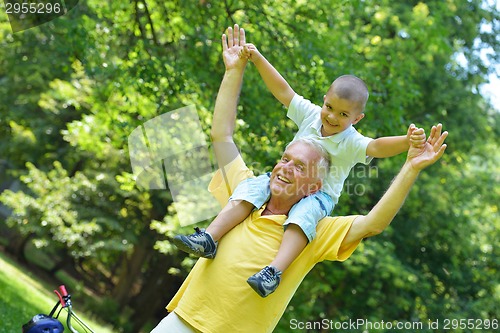 Image of happy grandfather and child in park