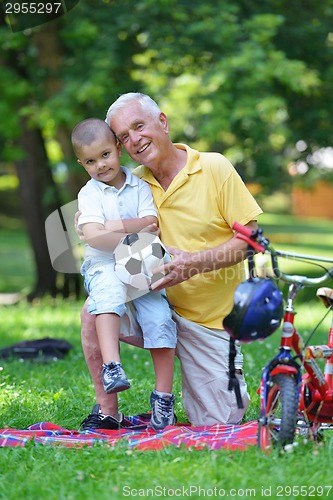 Image of happy grandfather and child in park