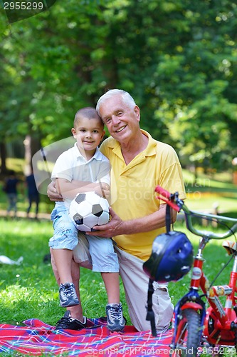 Image of happy grandfather and child in park