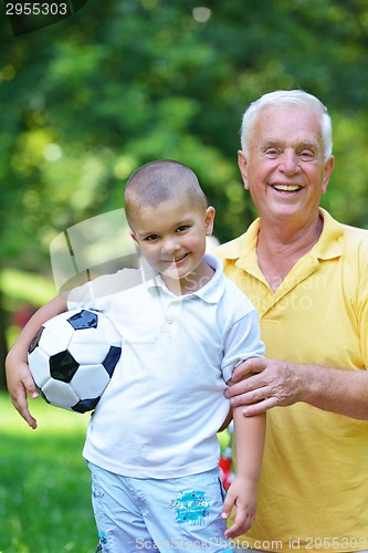 Image of happy grandfather and child in park