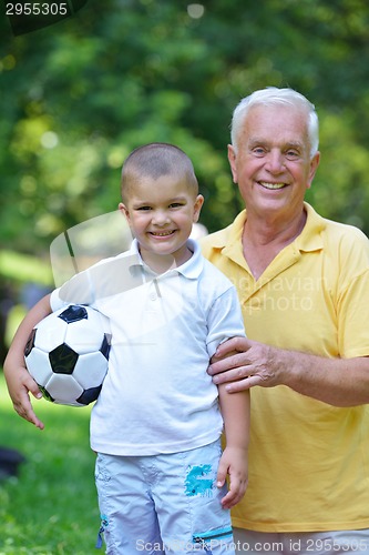 Image of happy grandfather and child in park