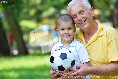 Image of happy grandfather and child in park