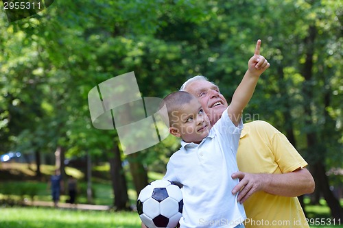 Image of happy grandfather and child in park