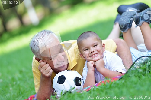 Image of happy grandfather and child in park