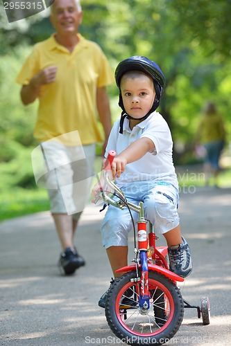 Image of happy grandfather and child in park