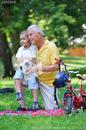 Image of happy grandfather and child in park