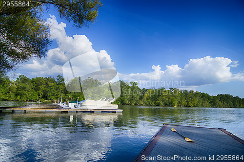 Image of boats at dock on a lake with blue sky