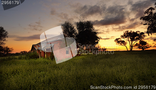 Image of Abandoned farm house at sunset