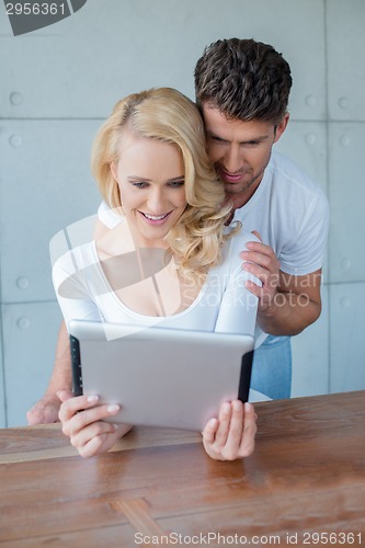 Image of Young couple reading information on a tablet-pc