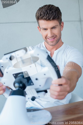 Image of Handsome Middle Age Man Playing Cool Gadget