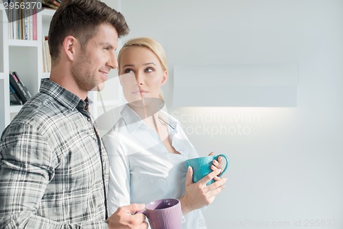 Image of Attractive couple standing in their living room