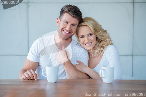 Image of Affectionate couple enjoying a morning coffee