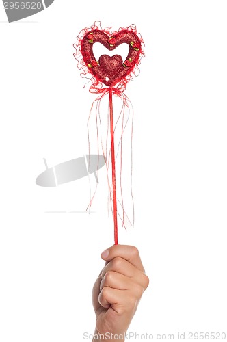 Image of Hand with heart on a stick