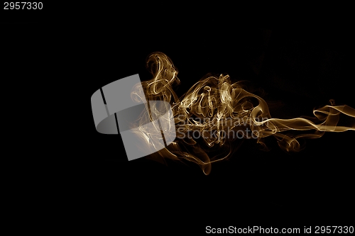 Image of Golden smoke on black background