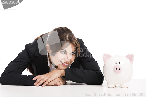 Image of Businesswoman with a piggy bank