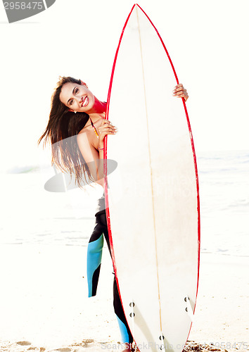 Image of Surfer girl with her surfboard