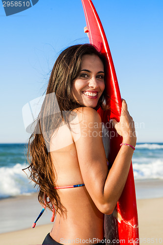 Image of Surfer girl with her surfboard