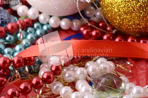 Image of String of pearls on red background