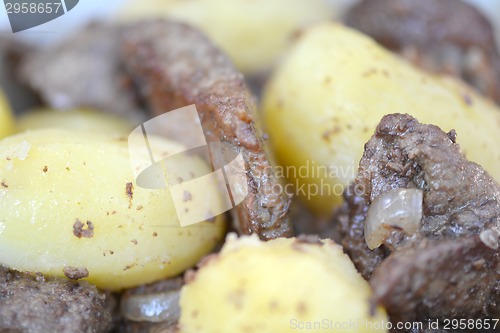 Image of Mixed grill on a plate, meat and potatoes