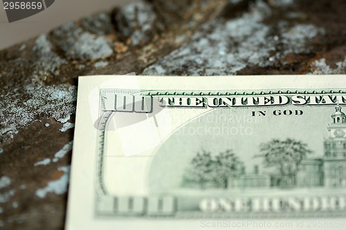 Image of Hundreds of US dollars on old wooden background