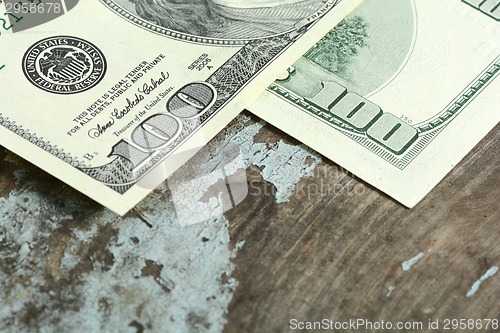 Image of Close-up of a $100 banknotes on wooden background