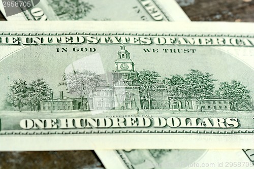 Image of One hundred dollars on wood background