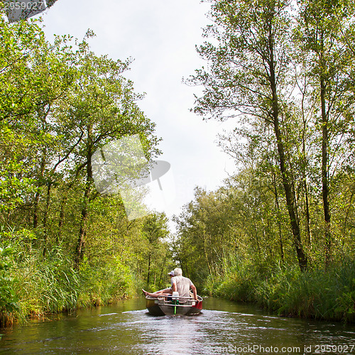 Image of Boat with unrecognisable people in the Weerribben