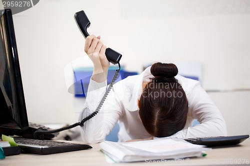 Image of Young attractive business woman with phone in hand