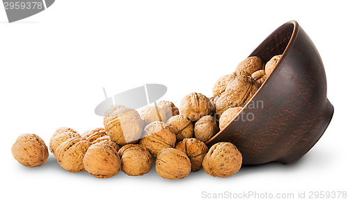 Image of Walnuts Spill Out Of A Clay Bowl