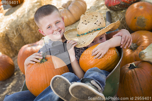 Image of Two Little Boys Playing in Wheelbarrow at the Pumpkin Patch