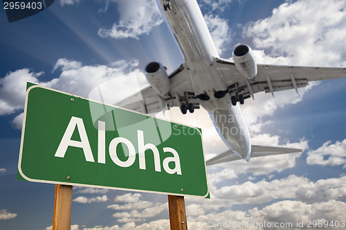 Image of Aloha Green Road Sign and Airplane Above