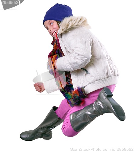 Image of isolated autumn portrait of child with hat, scarf and boots jumping 
