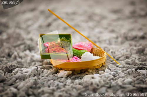 Image of Offerings to gods in Bali with flowers, rice and aroma stick