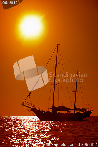 Image of Silhouette of sailing yacht in the tropical sea at sunset. Thail