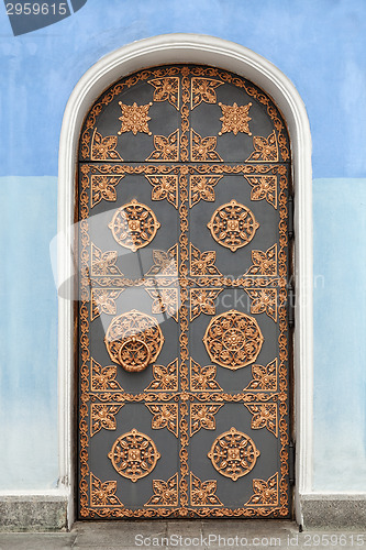 Image of Old building door decorated with golden ornaments