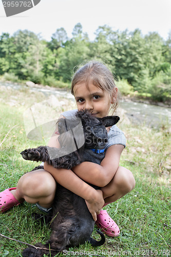 Image of Little girl and her puppy