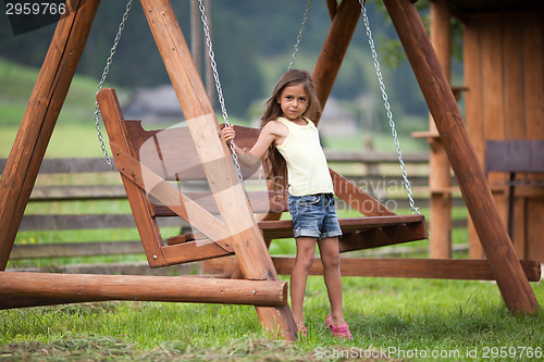 Image of Little girl and swing