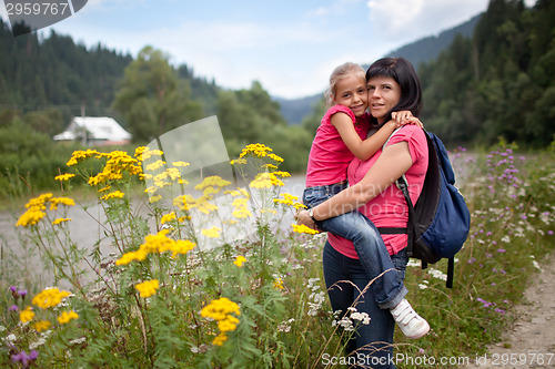 Image of Mother holds daughter on hands