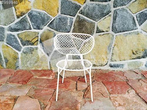 Image of White chair on colorful tile background